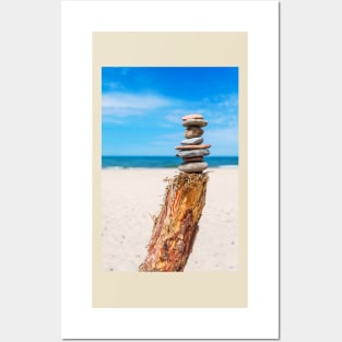 Stack of stones on the beach against blue sky Posters and Art